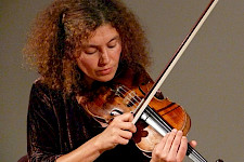 lockige Frau spielt eine Violine
