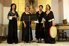 4 Frauen in Folklorekleidung singen auf einer Bühne