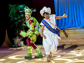 1 Frau in grünen Käferkostüme und 1 Mann mit weißen arabischen Klamotten tanzen